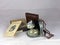 Isolated closeup shot of an old metallic compass with its box, case, and handbook