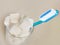 Isolated conceptual still life image of toothbrush and refreshment glass full of sugar cubes in dental care and oral hygiene conce