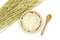 Isolated Cooked Jasmine rice in the wooden bowl with ear of rice on white background