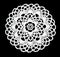 Isolated crocheted laced white doily with many picos at the egde on a black background. Round decorative cotton doily