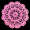 Isolated crocheted pink doily with a pattern of cones, leaves and arches on a black background. Round decorative cotton doily