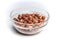 Isolated crystal bowl with hazelnuts against white background