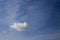 Isolated cumulonimbus cloud and cirrus on a blue sky background