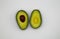 Isolated cut two halves ripe avocado fruit brown pit, with white blank background