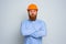 Isolated doubter architect with beard and orange helmet