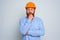 Isolated doubter architect with beard and orange helmet