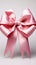 Isolated elegance pink ribbon adorned with bow, set against a clean white backdrop