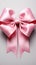 Isolated elegance pink ribbon adorned with bow, set against a clean white backdrop