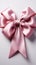 Isolated elegance pink ribbon adorned with bow, set against a clean white backdrop