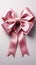 Isolated elegance pink ribbon adorned with bow, set against a clean white backdrop