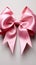 Isolated elegance pink ribbon adorned with bow, set against a clean white backdrop