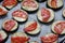 Isolated filled frame close up shot of uncooked raw sliced aubergine eggplant with thin tomato slices on top sprinkled with dry