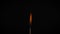 Isolated flame burning on a match on a black background