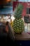 Isolated fresh Pineapple on dark wood rectangular narrow wooden shelf