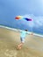Isolated. Games with parachute. A man walks along the shore. Beautiful view. Active lifestyle. A man is holding a parachute.