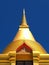 Isolated golden stupa soars into blue sky