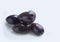 Isolated group of black olives on a white background.