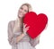 Isolated happy young blond caucasian woman Holding red heart.