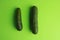 Isolated high angle top view closeup shot of cucumbers on a green table