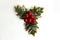 Isolated holly berry with leaves. Plastic, artificial Ilex berries on sprig.