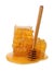 Isolated honey. Honeycomb beeswax with fresh liquid yellow honey and dipper spoon on white background