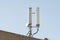 Isolated image of 5G and wireless communications mast seen atop a private office roof.