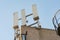 Isolated image of 5G and wireless communications mast seen atop a private office roof.