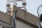 Isolated image of 5G and wireless communications mast seen atop a private office roof.