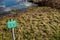 Isolated image of a Danger Sign seen positioned near a deep, open river and adjacent quick sands.