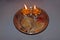 Isolated image of Indian Puja thali with two lit lamps