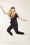 Isolated image of joyful jumping girl in stylish black clothes.