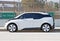 Isolated image of a late model BMW i3 parked along the road