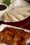 Isolated image of Peking lacquered duck accompanied by crepes and sauce. Vertical image