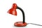 Isolated iron, red, table lamp on an isolated white background.