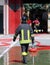Isolated Italian fireman with protective uniform and helmet