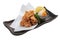 Isolated Japanese deep fried Chicken Karaage with cooking paper served with tempura sauce Tentsuyu mixing mince radish.