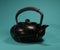 Isolated Kintsugi ceramic kettle teapot in the blue background