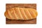 Isolated loaf of bread on wooden rectangular cutting board on white background.