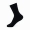 Isolated long black men`s sock on invisible mannequin foot on white background, side view.