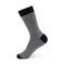 Isolated long gray men`s sock on invisible mannequin foot on white background, side view.