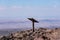 Isolated metal information stand on a top of a mountain