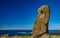 Isolated Moai against ocean with blue sky - Easter Island