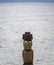 Isolated Moai statue with ocean in the background