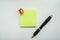 Isolated mock up green sticky note with pen