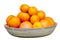 Isolated monochrome orange color citruses fruits on the plate. Oranges, mandarines and tangerines on white background