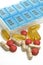 Isolated Multiple Vitamins and Medications with Weekly Container on White