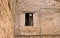 Isolated open window in a medieval brick wall Fiorenzuola di Focara, Italy, Europe