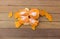 Isolated Orange being peeled on the wooden floor.