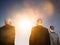 Isolated photo of Rear view of three business people looking at sun