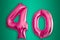 Isolated pink gold Helium Balloon in the shape of the number 40